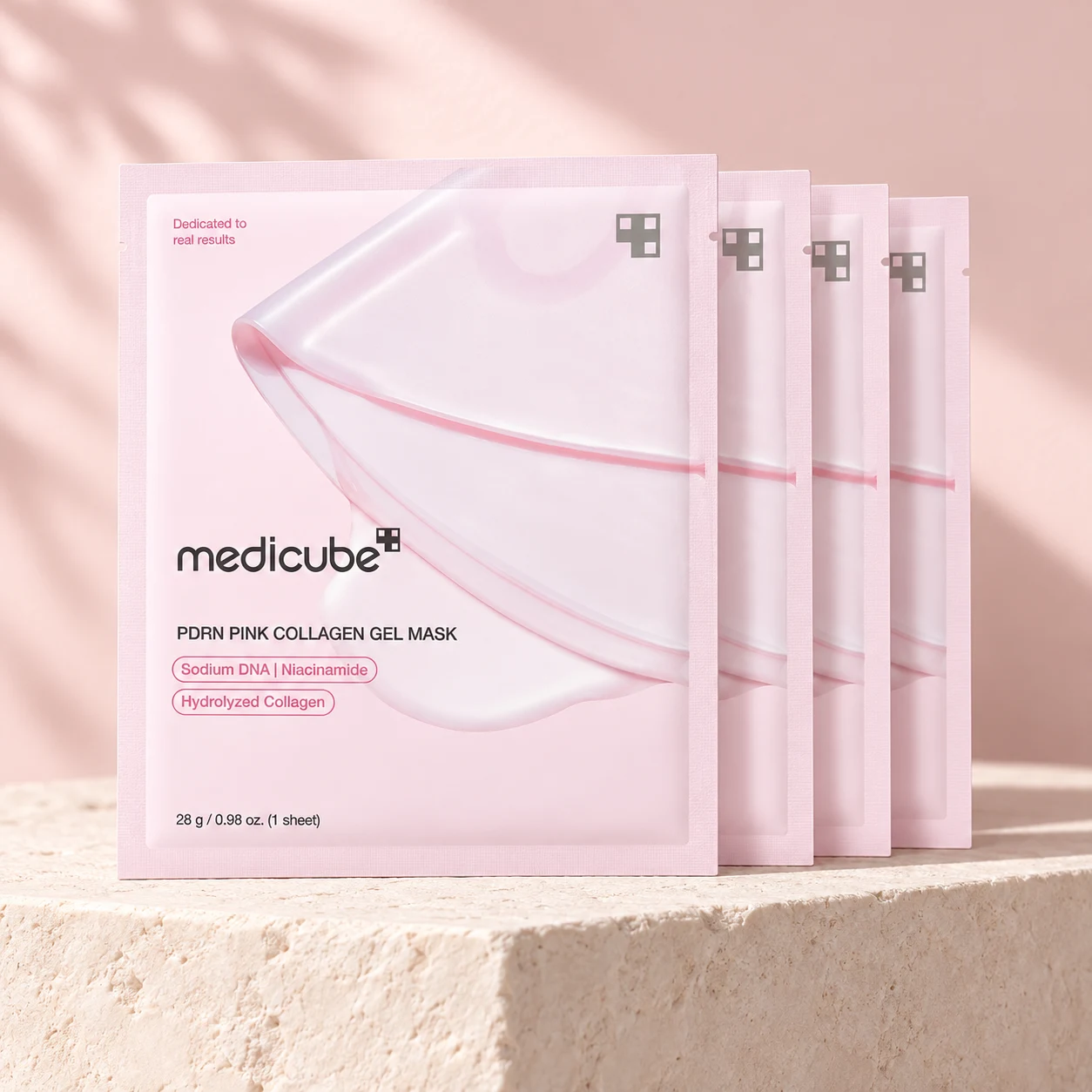 Styled rendering of four Medicube Pink Collagen Gel Mask sachets